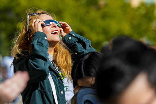 A UNT student watches the October 14, 2023 annular solar eclipse