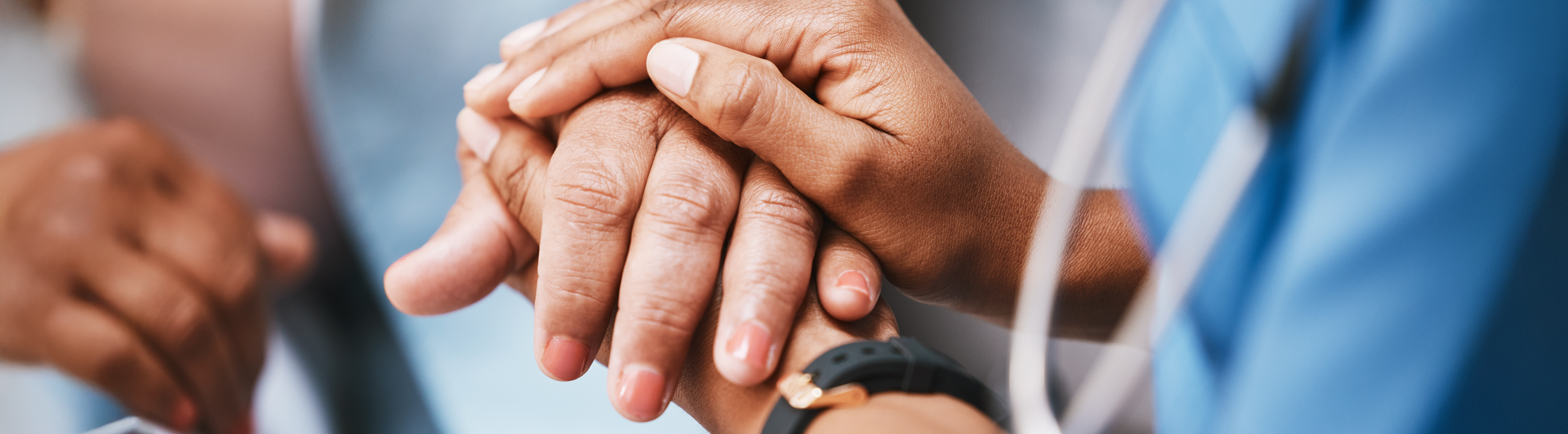 Top horizontal photo banner of nurse's hands holding hands with a patient for consulting support and healthcare advice