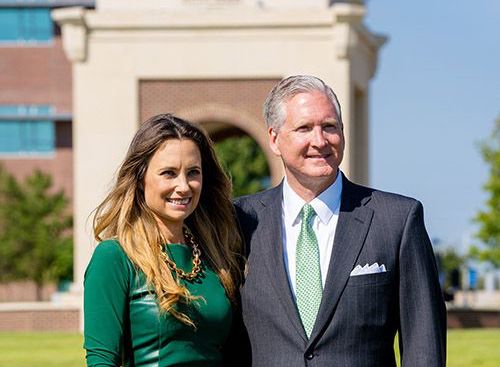 amanda-and-g-brint-ryan-in-front-of-ryan-tower-at-unt-dallas-portrait