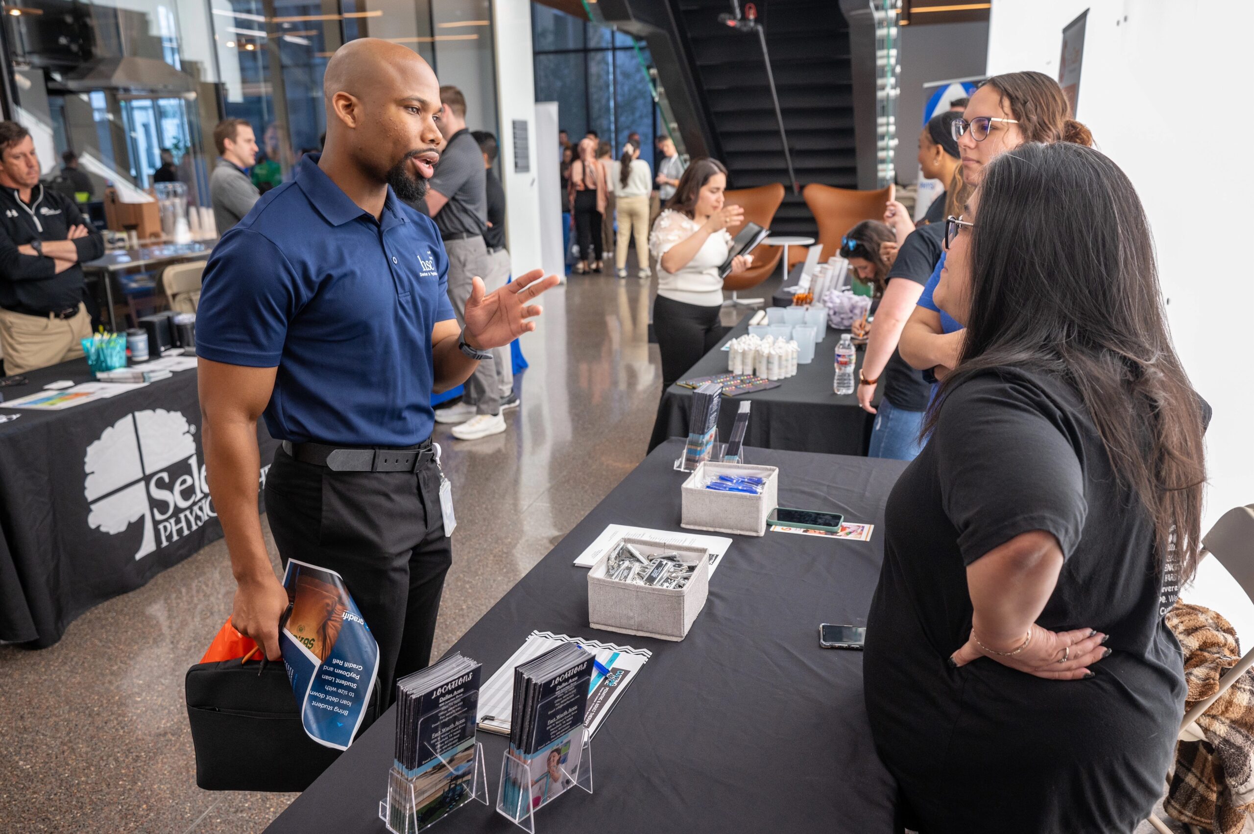 Physical therapy career fair attendees speaking to vendors