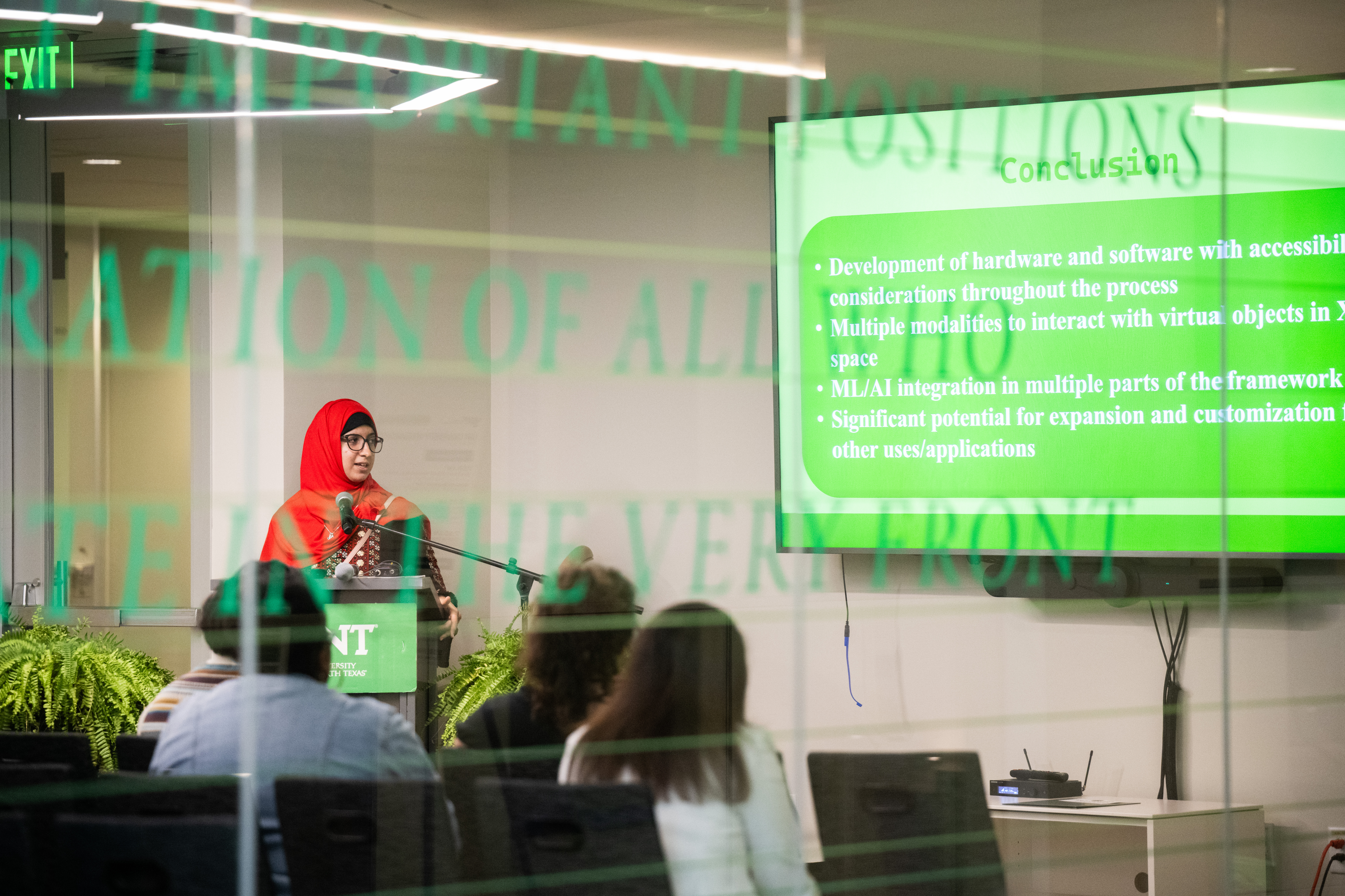 A photo of UNT's Electrical engineering Ph.D. student Danah Omary presents her research during the afternoon Student Showcase.