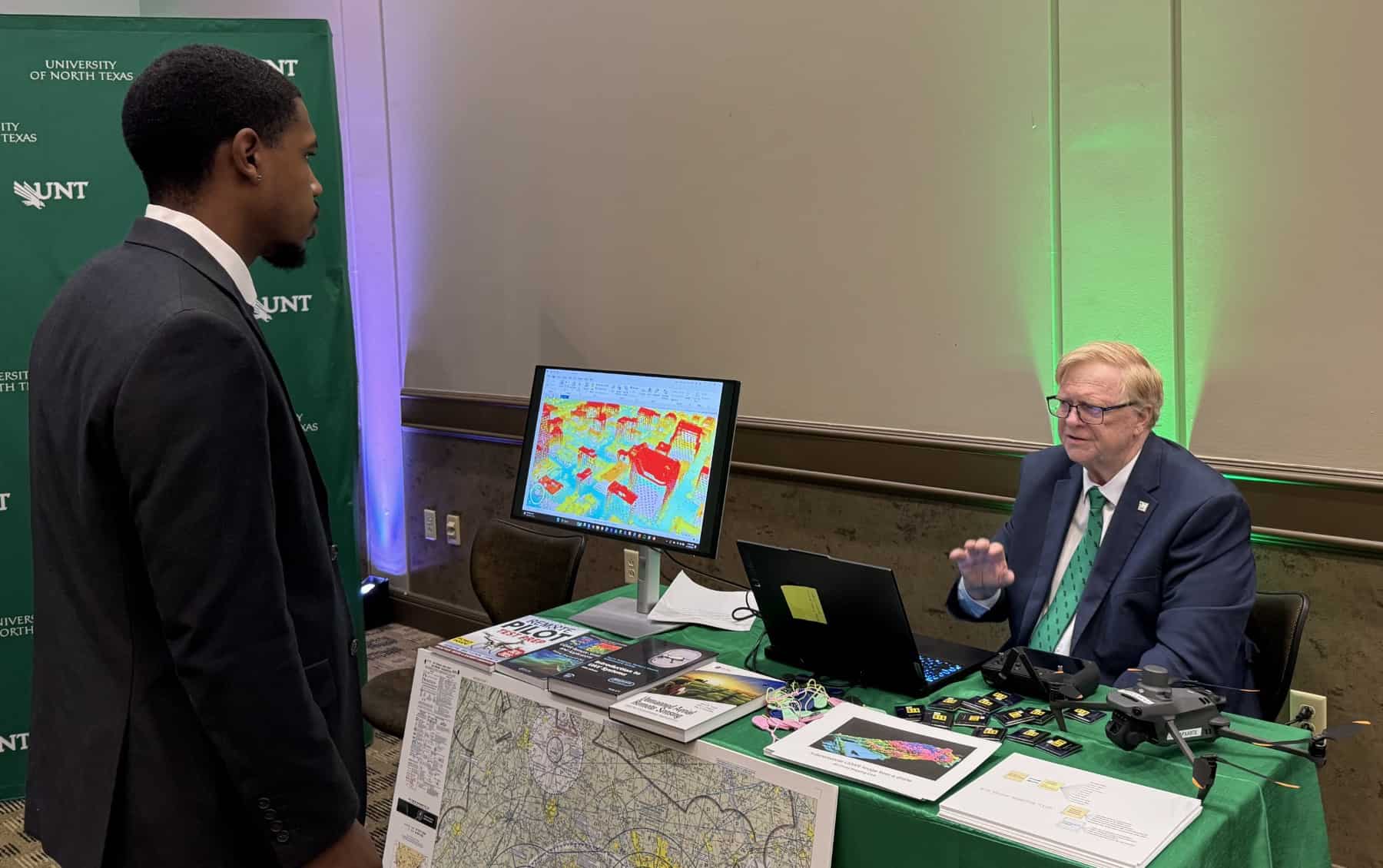 Full photo showing UNT Geography & the Environment lecturer John South providing information on drones