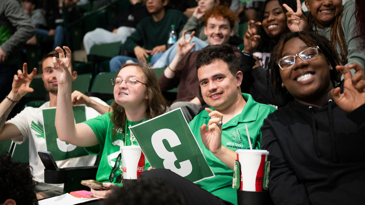 UNT's Noah Rahn (third from the left) cheering on the UNT men's basketball team