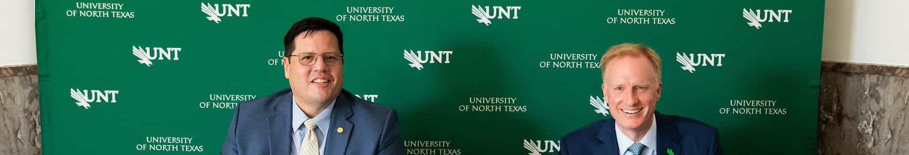Top horizontal narrow cropped photo banner of Grayson College president Dr. Jeremy McMillen (left) and UNT president Dr. Harrison Keller