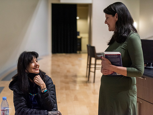 Harjo speaks with an attendee during her book signing