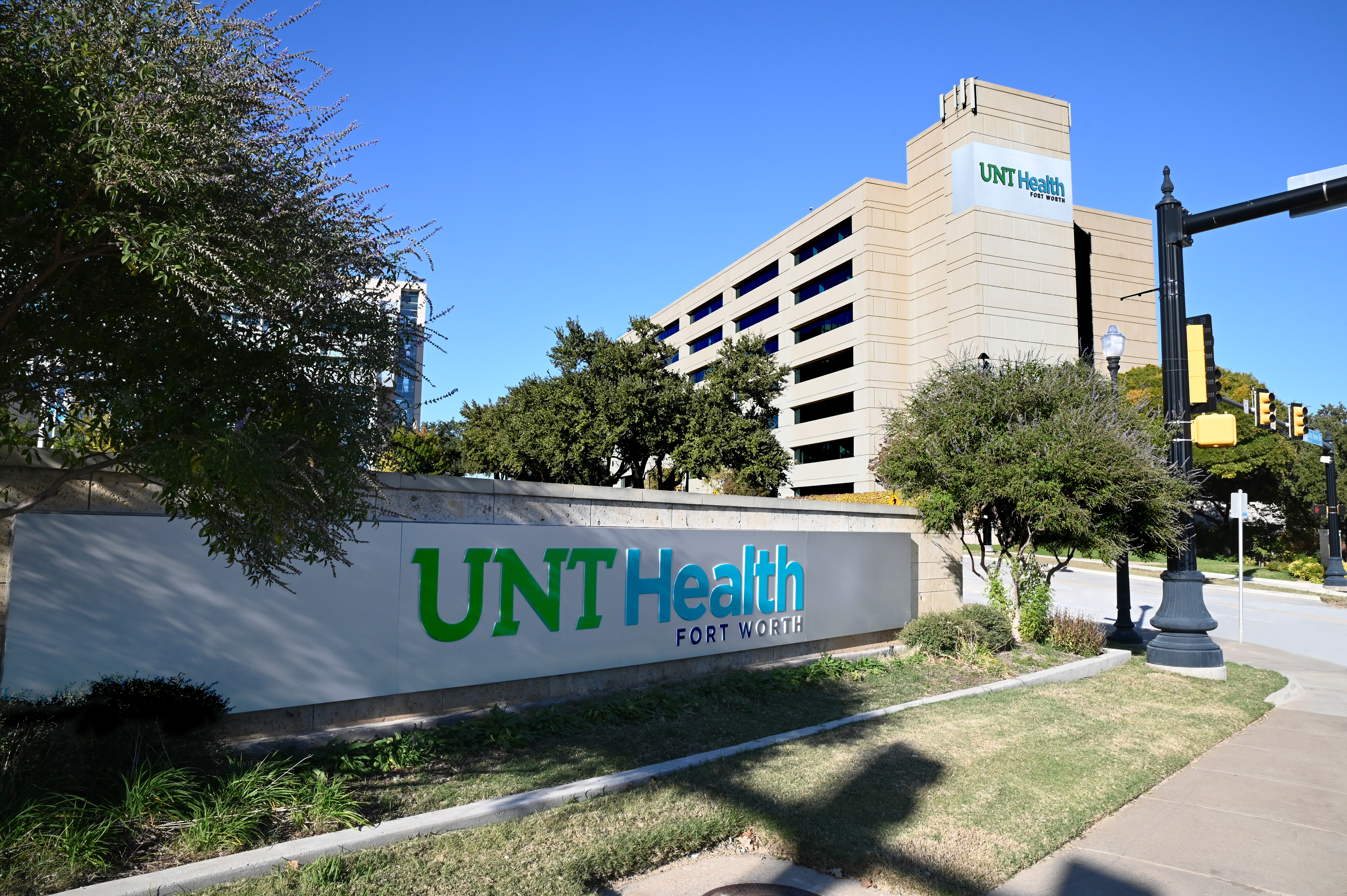 Photo of UNT Health Fort Worth campus building with entrance sign on a sunny day