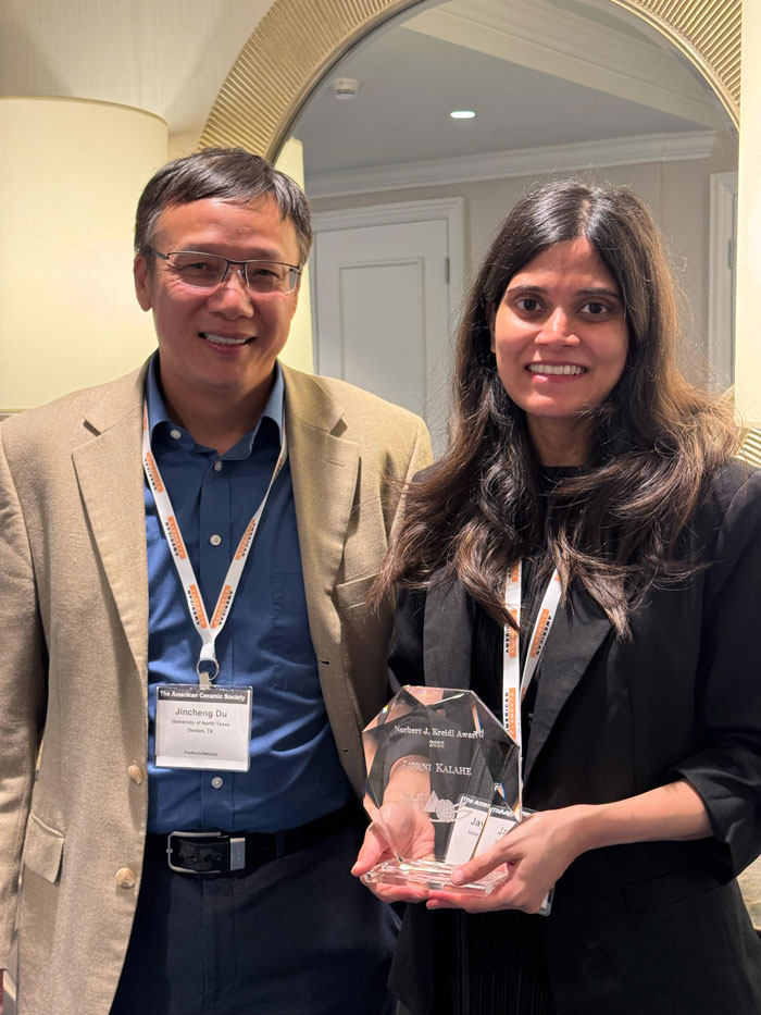 Photo of UNT's (pictured on left) professor Jincheng Du standing next to Jayani Kalahe holding her award 