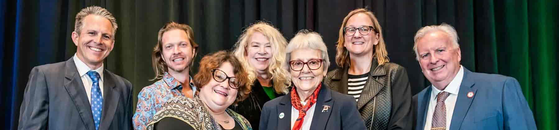 Top photo banner of UNT Libraries staff together in the middle with 2 of the (uncredited) award presenters at 2025 the Texas Historical Commission Governor's Award for Historic Preservation