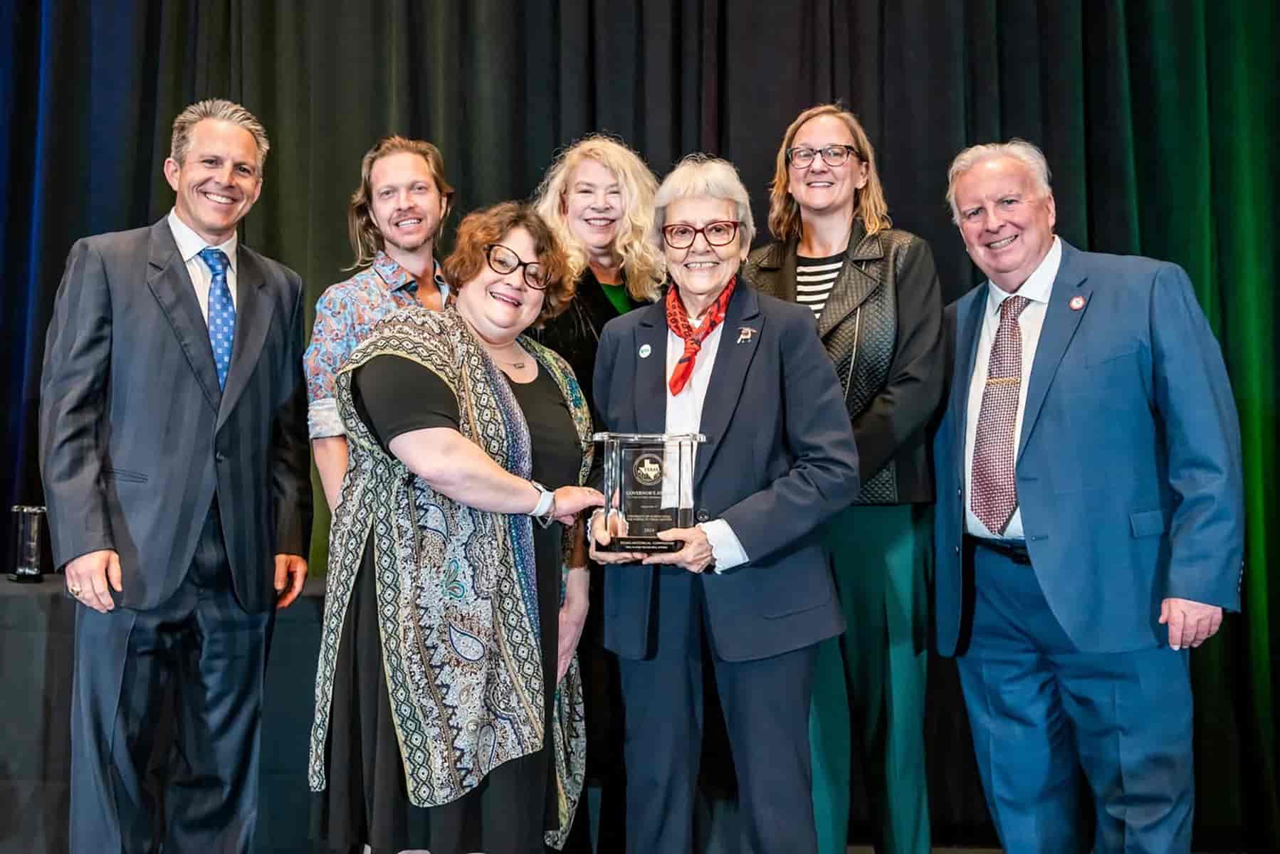 Photo of UNT Libraries staff accept the Texas Historical Commission Governor's Award for Historic Preservation at the 2025 Real Places Conference in Austin, Texas