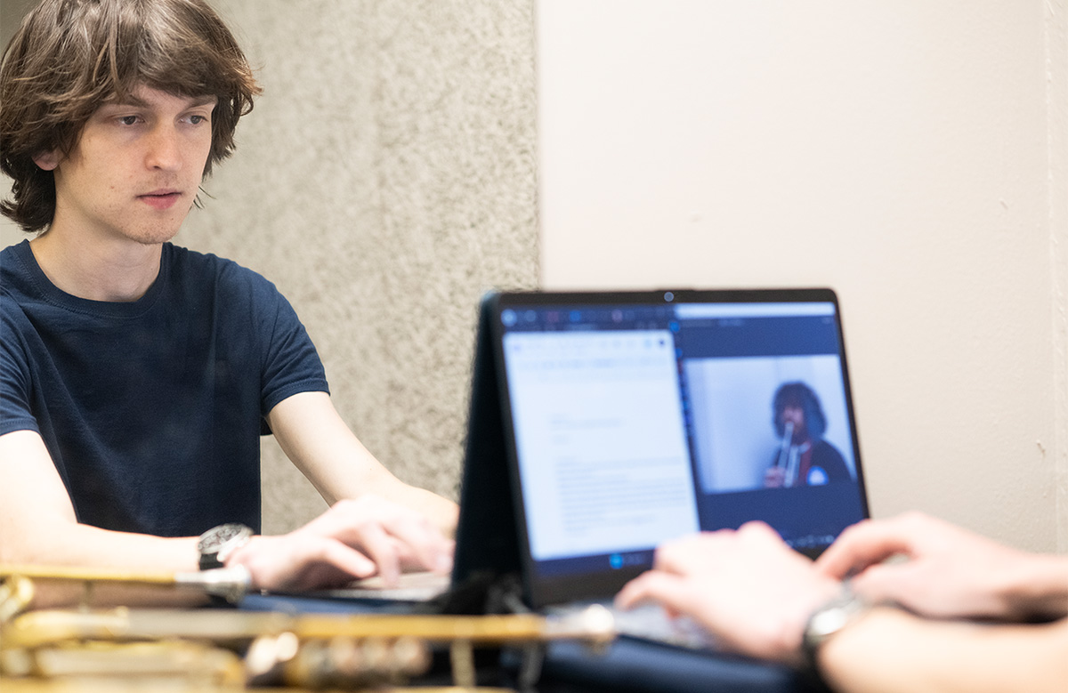 Nathan Fisher, a first-year master’s student studying jazz trumpet, in a virtual music lesson with a Dallas ISD student