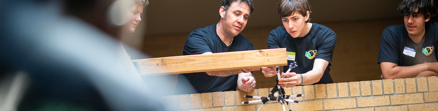 Top banner photo of UNT faculty helping students learn about physics-based formulas being applied to building items such as bridges