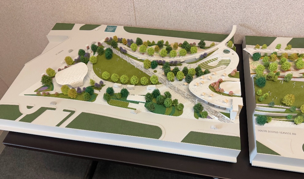 Photo of a miniature scaled down model showing building structures, roads, highways, and landscaping for the Gateway project