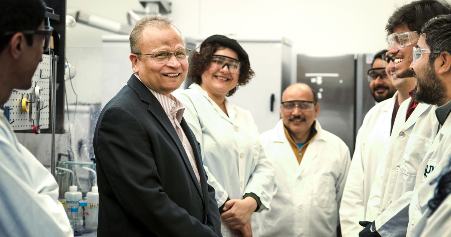 Full photo of UNT's Professor Francis D’Souza with a small group of graduate students.
