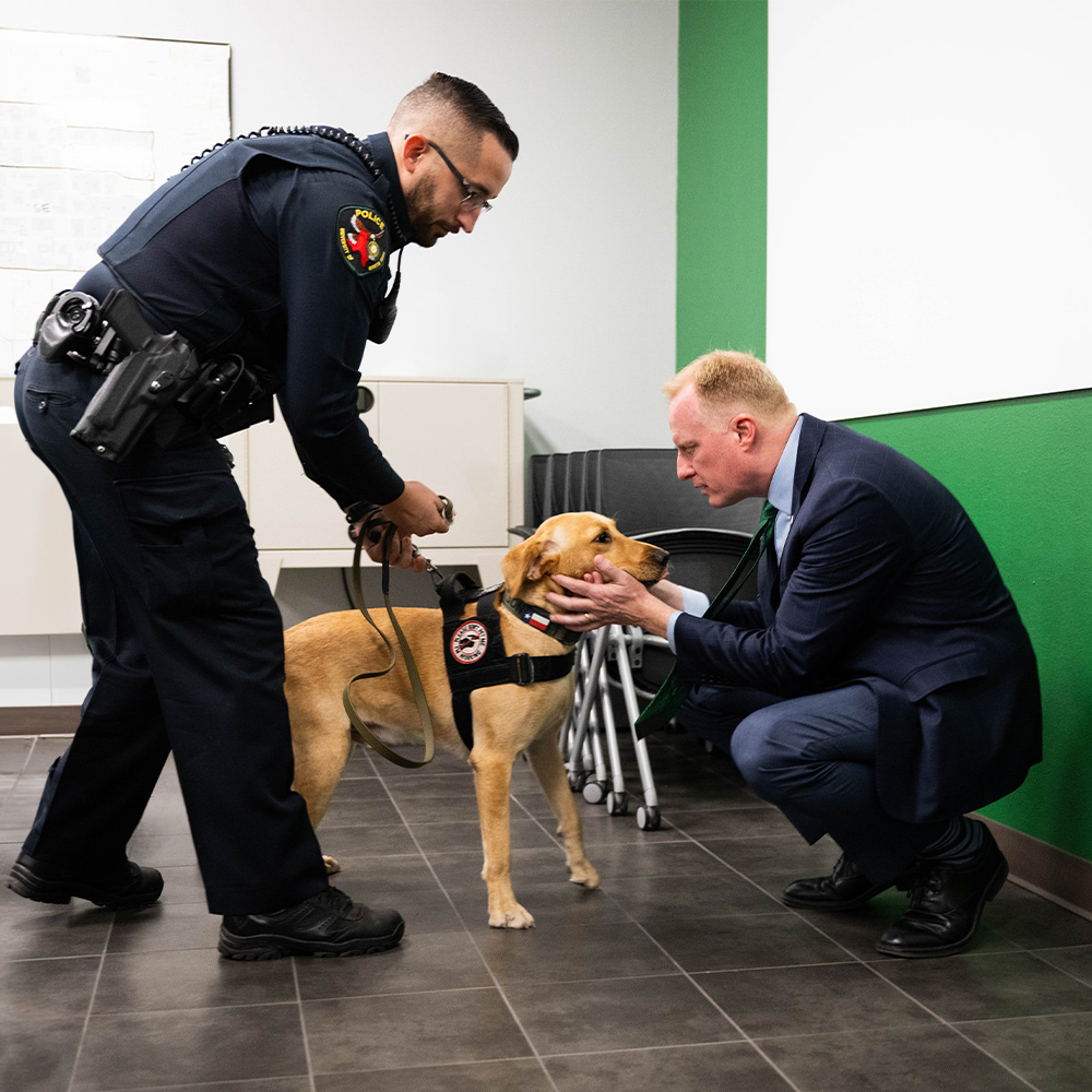 UNT Police's Officer Cioffi and K-9 Watson with UNT's 17th President Dr. Harrison Keller 