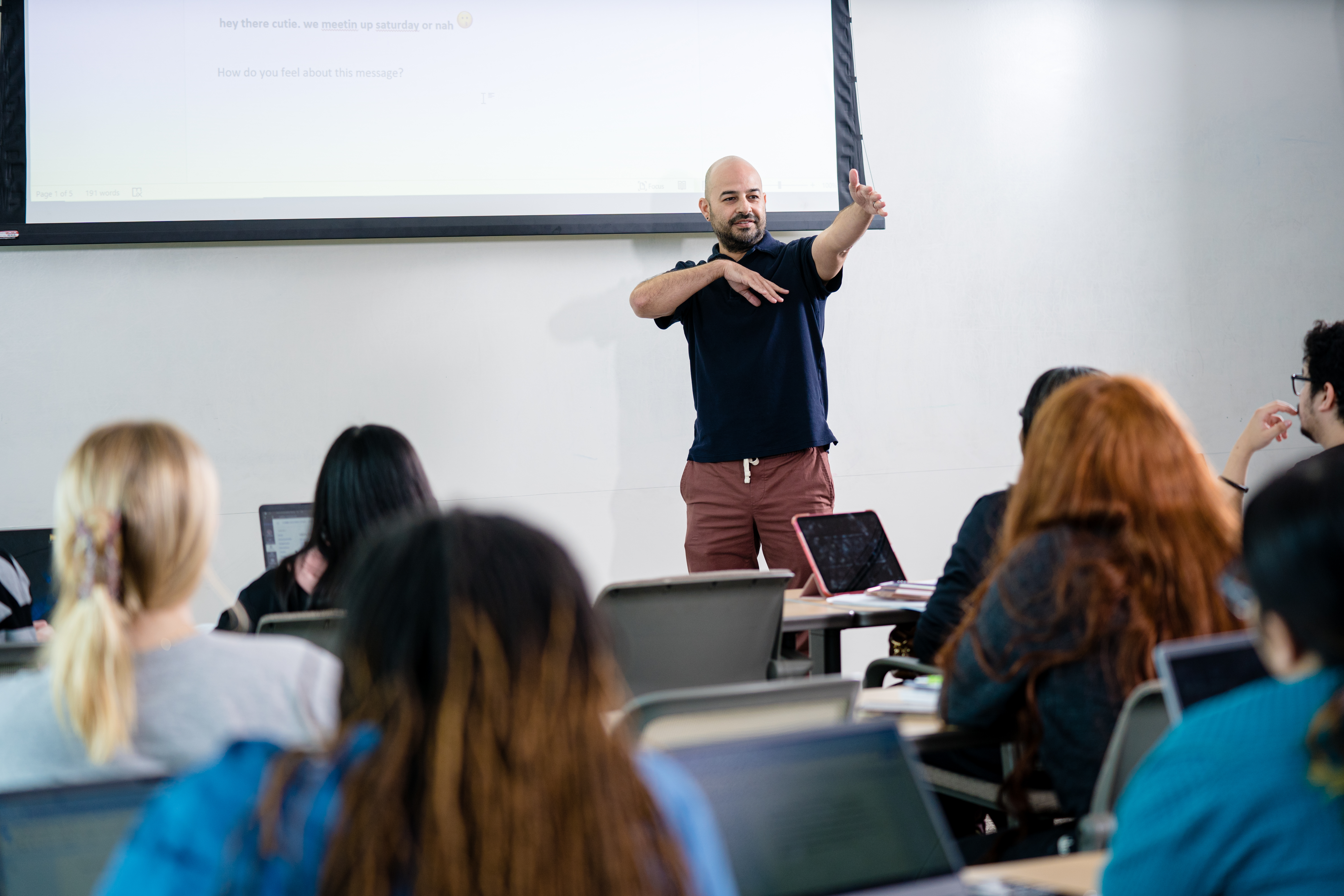 Photo of Robert Tinajero, Associate Professor of English and Rhetoric, makes a point to students during a UNT Dallas english class 