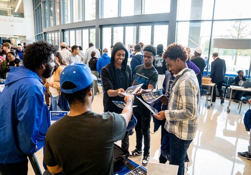 A photo of high High school students discovering UNT Dallas Esports opportunities at the 2024 True Blue Open House. 