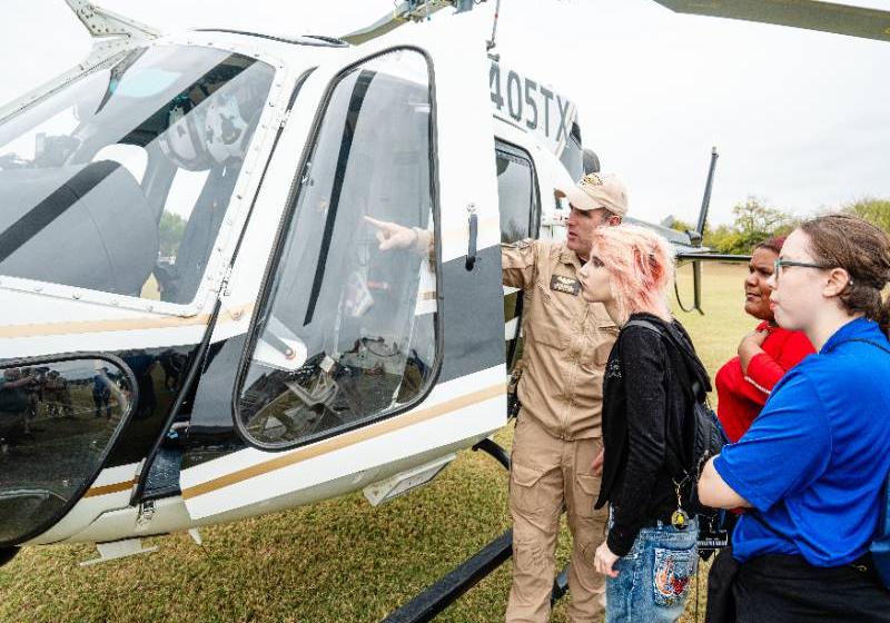 A State Trooper shows a Texas DPS Helicopter to visiting high school students Photo a State Trooper shows a Texas DPS Helicopter to visiting high school students