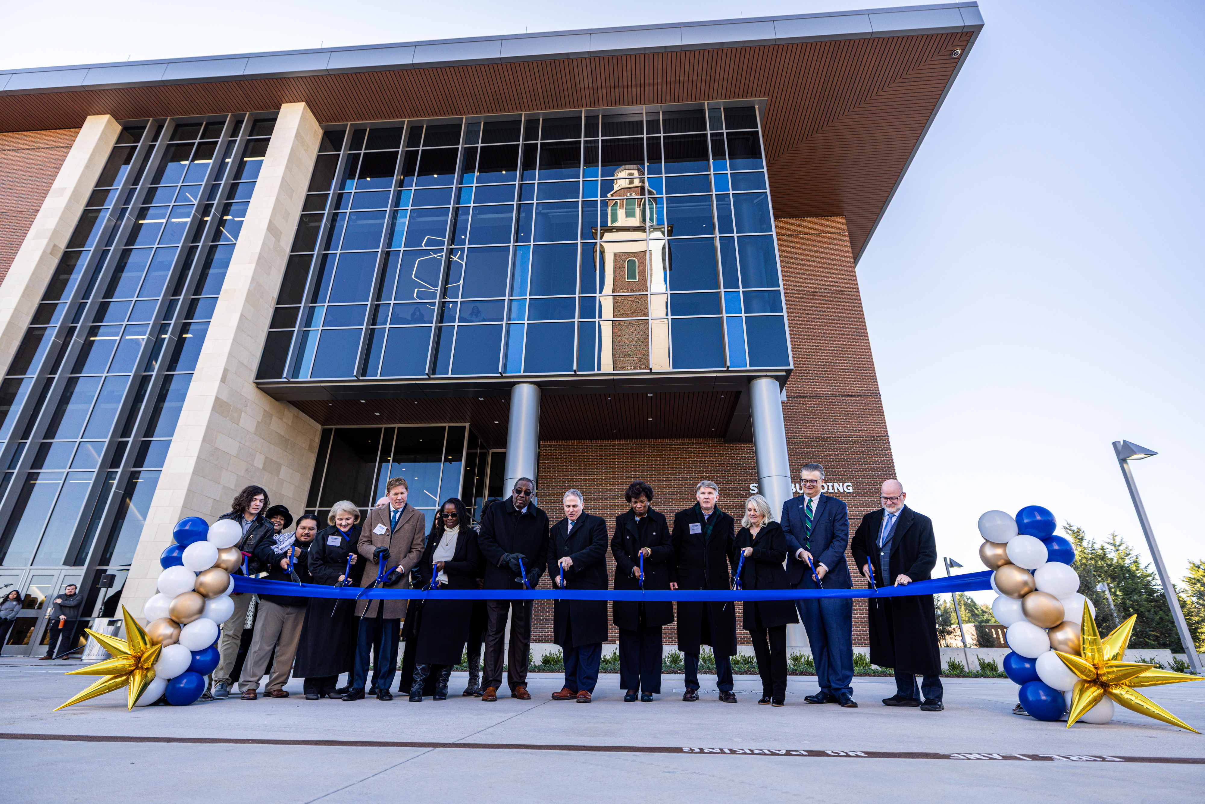 Photo of dignitaries gather at the ribbon-cutting ceremony for the UNT Dallas STEM Building in December 2025
