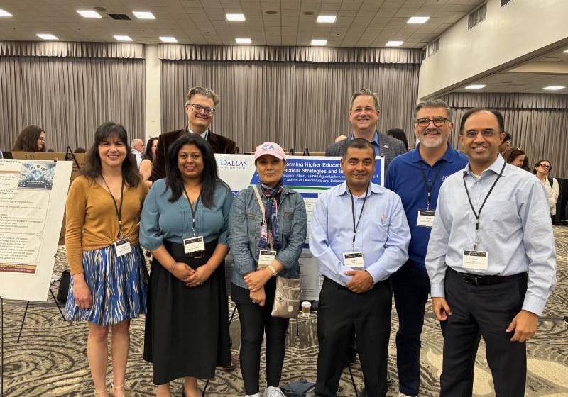 Photo of 8 UNT Dallas leaders and faculty members including Dr. Milan Sevak (on the far right) at an AI conference in Orlando 