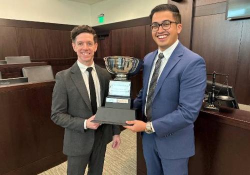 Photo of Stan Borodyansky and Alex Valdez hold their trophy after winning the 2023 Thompson Coburn Moot Court Competition