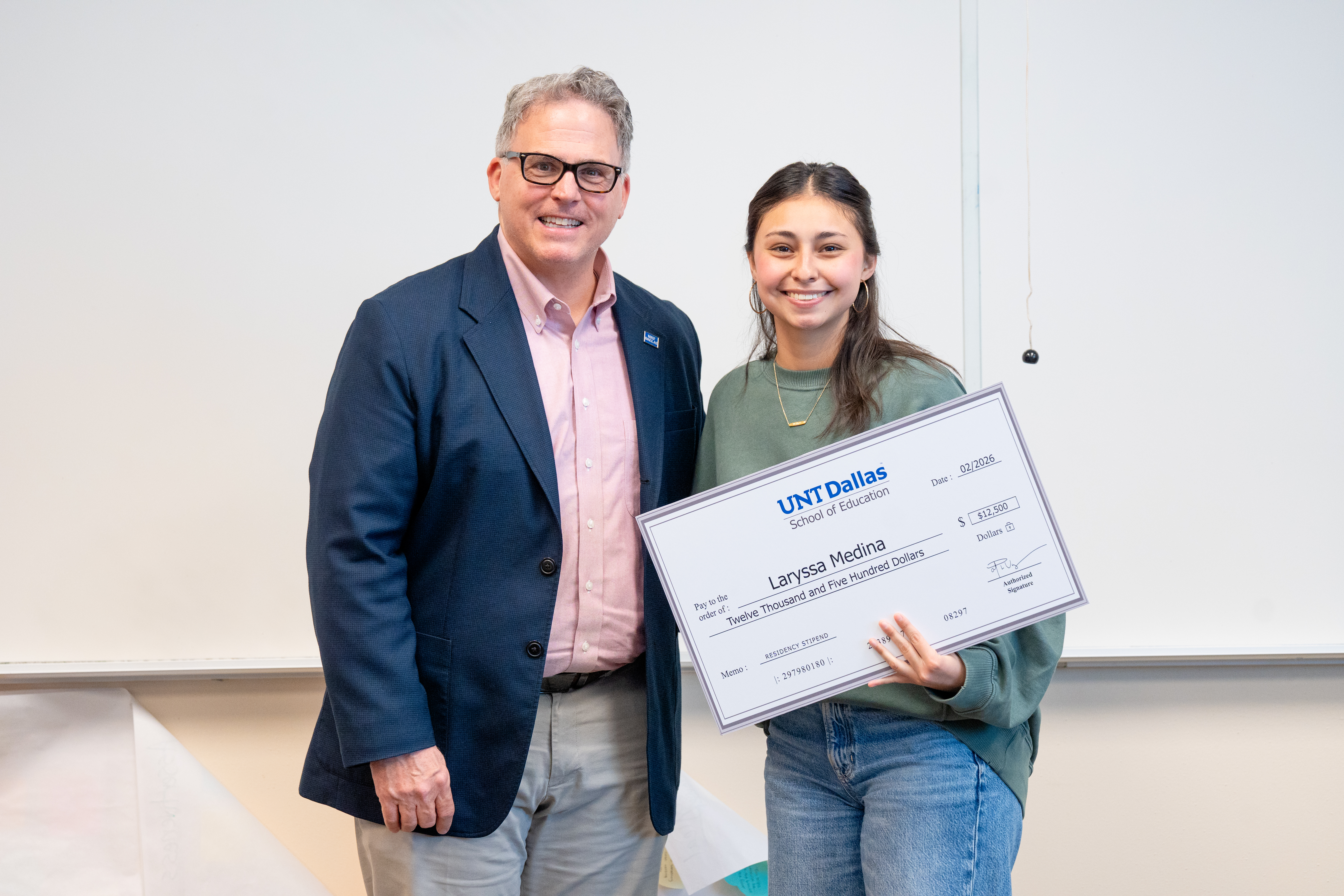 UNT Dallas President Warren von Eschenbach with student-teacher Laryssa Medina Photo of UNT Dallas President Warren von Eschenbach with student-teacher Laryssa Medina holding a representation of her $12,500 check.