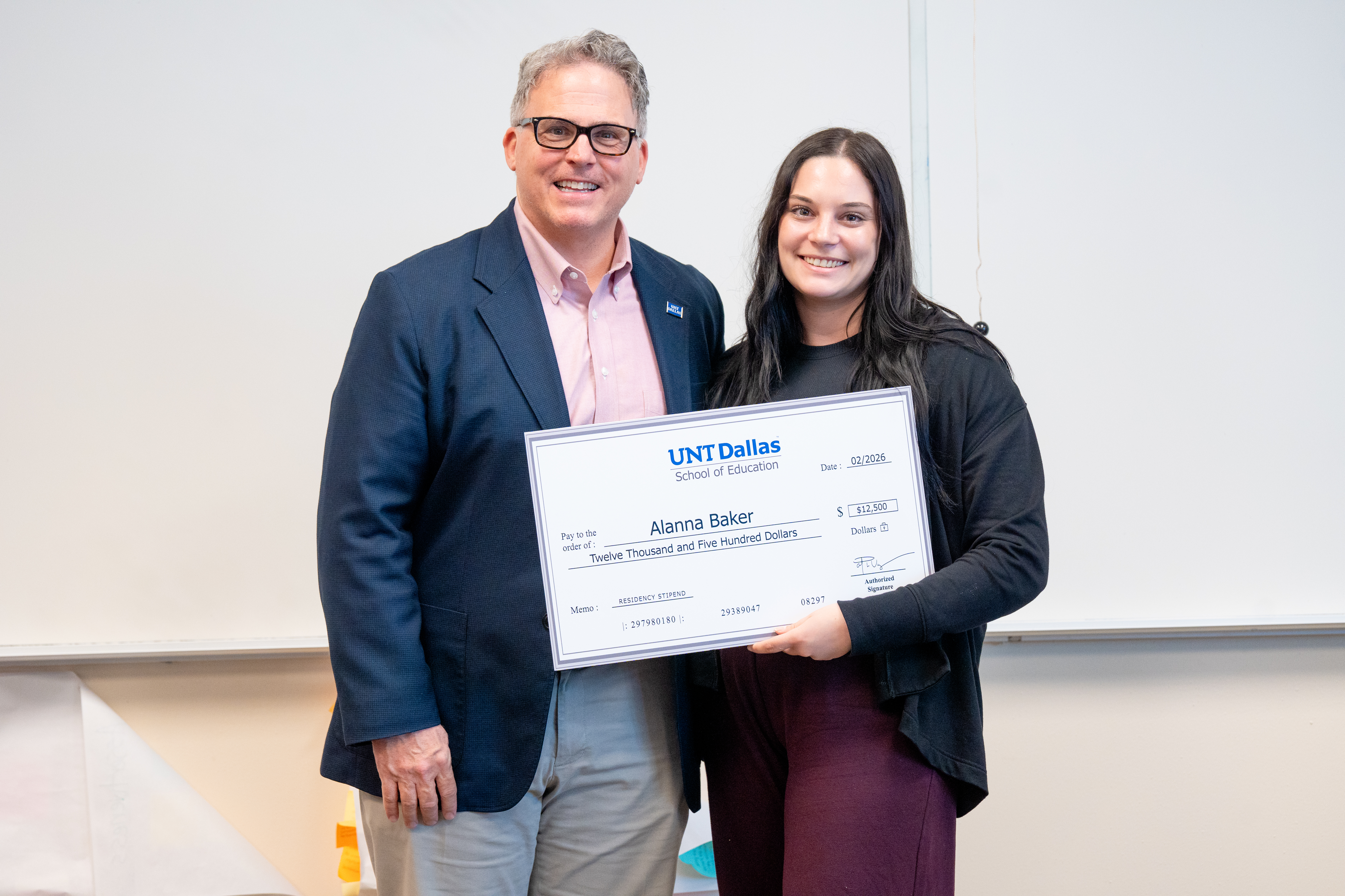 UNT Dallas President Warren von Eschenbach with student-teacher Alanna Baker Photo of UNT Dallas President Warren von Eschenbach with student-teacher Alanna Baker holding a representation of her $12,500 check.
