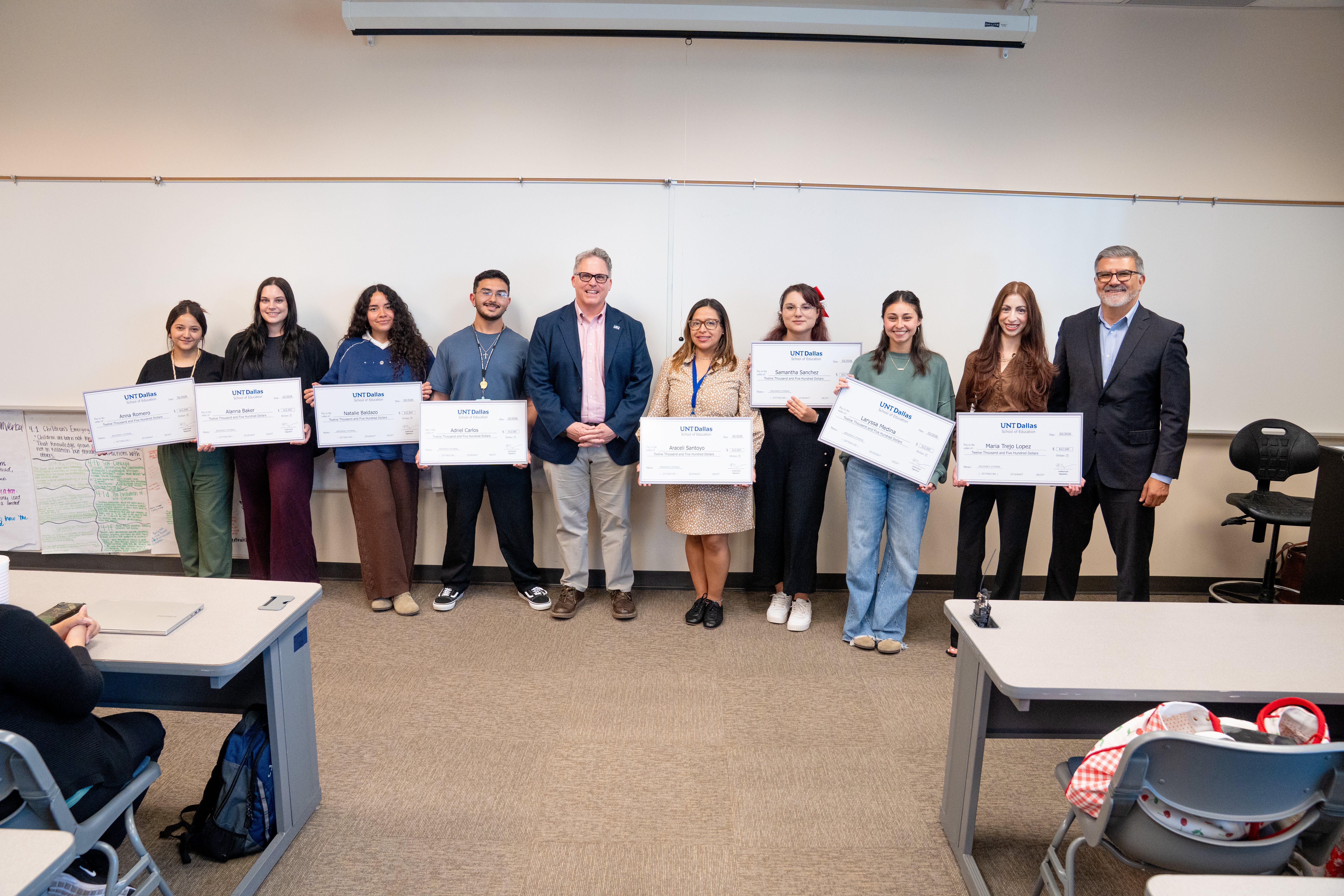 Students in the Teacher Residency Program received checks for $12,500 Full uncropped photo of UNT Dallas President Warren von Eschenbach standing in the middle of a lineup consisting of Teacher Residency Program students after being presented a $12,500 stipend check to a at a special recognition ceremony. School of Education Interim Dean Dr. Patrick Valdez is on the far right.
