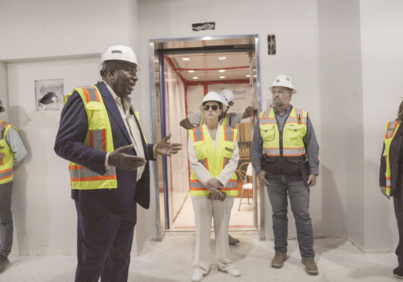 Photo of university leaders with State Sen. Royce West reviewing the progress made on the new UNT Dallas STEM building 