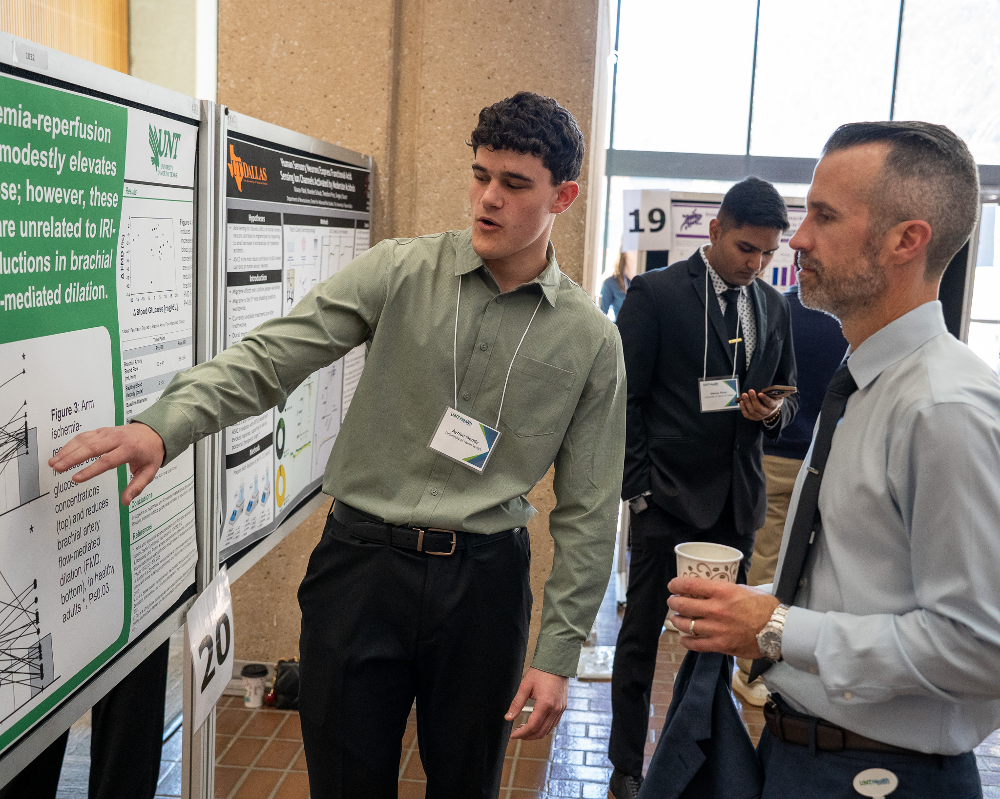 Ayrion Moody shows his abstract board to Dean Keller as he discussions and answers questions at the Student Research Spotlight Photo of Ayrion Moody from the University of North Texas as he discussions and answers questions at the Student Research Spotlight.