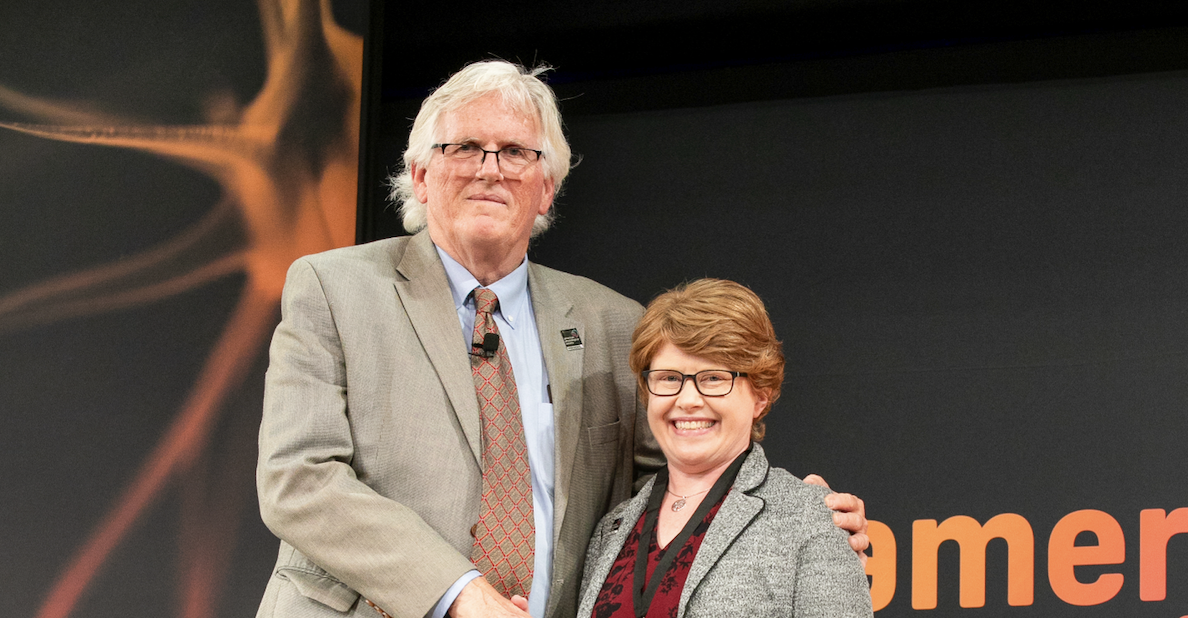 Cropped photo of Robert L. Hester, one of the APS Board of Directors and president with UNT Health's Dr. Caroline Rickards, wearing her award medal.