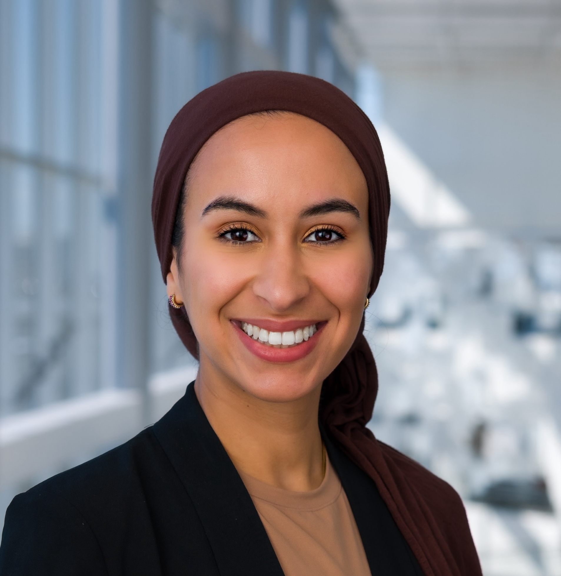 Photo portrait of UNT Health's Noura Farih in a head covering posing in front of blue backdrop