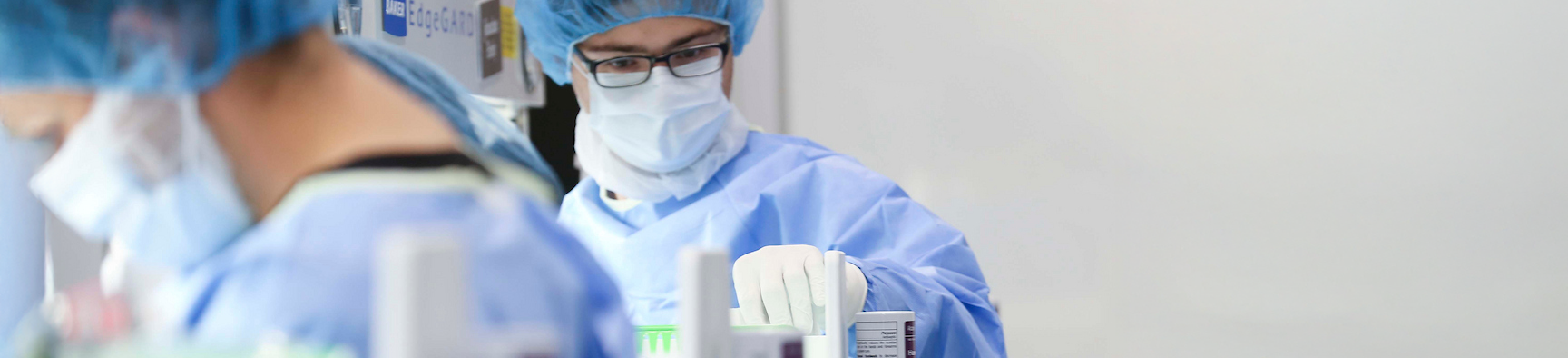 Photo of UNT Health's students wearing protective gear and masks work with laboratory research equipment in a pharmacy lab Top horizontal narrow cropped photo banner of UNT Health's students wearing protective gear and masks work with laboratory research equipment in a pharmacy lab