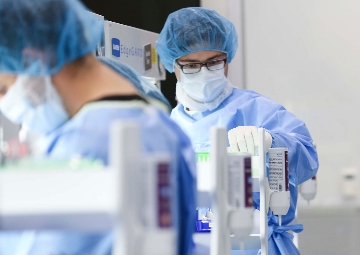 UNT Health's students working in a research pharmacy lab class. Full uncropped photo of UNT Health's students wearing protective gear and masks work with laboratory research equipment in a pharmacy lab