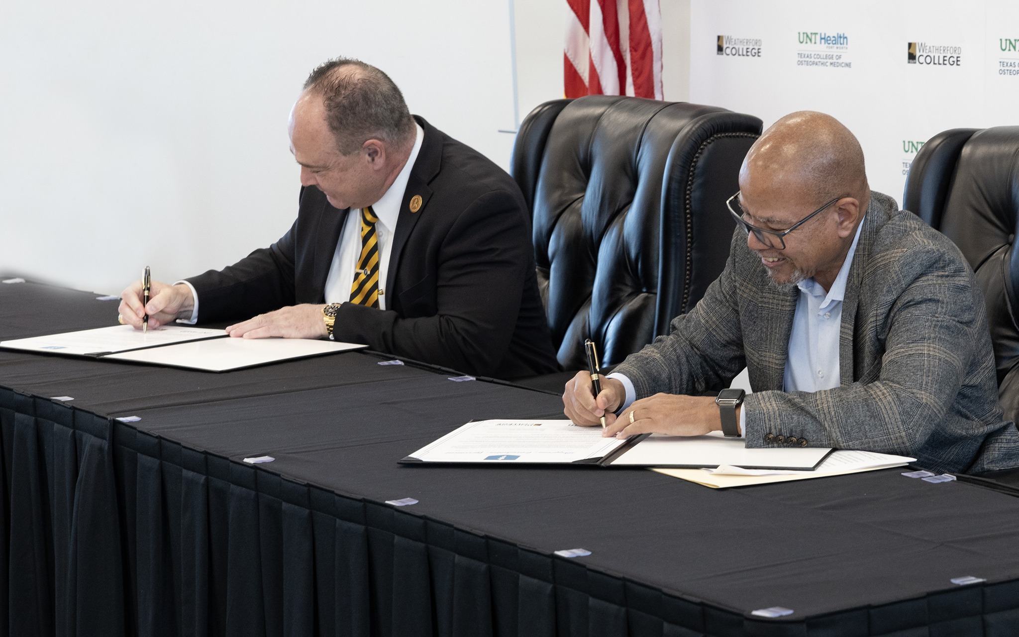 Dr. Farmer with Dr. Calhoun sign agreement Photo of both presidents, Dr. Tod Allen Farmer from Weatherford College and Dr. Kirk Calhoun from UNT Health, signed their formal agreement documents during their official signing ceremony.