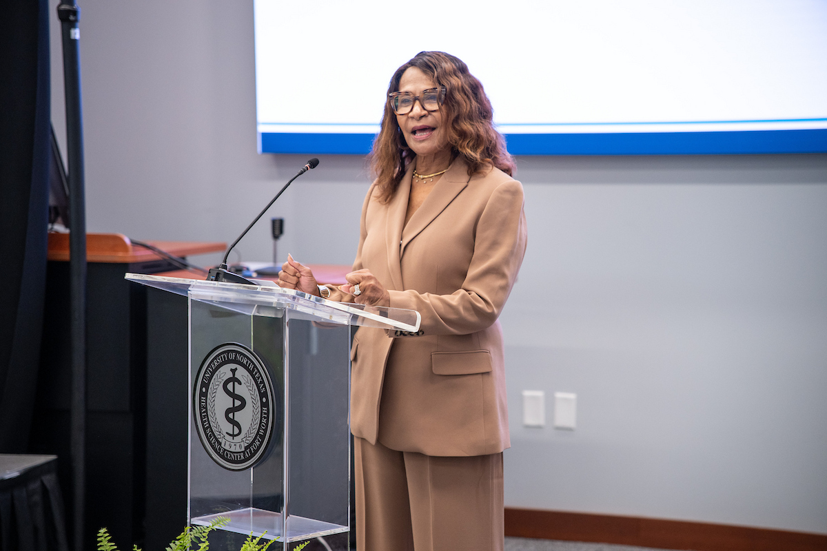 Photo of Jeanette Calhoun speaking at a clear plexiglas podium during the 2026 Leadership Texas