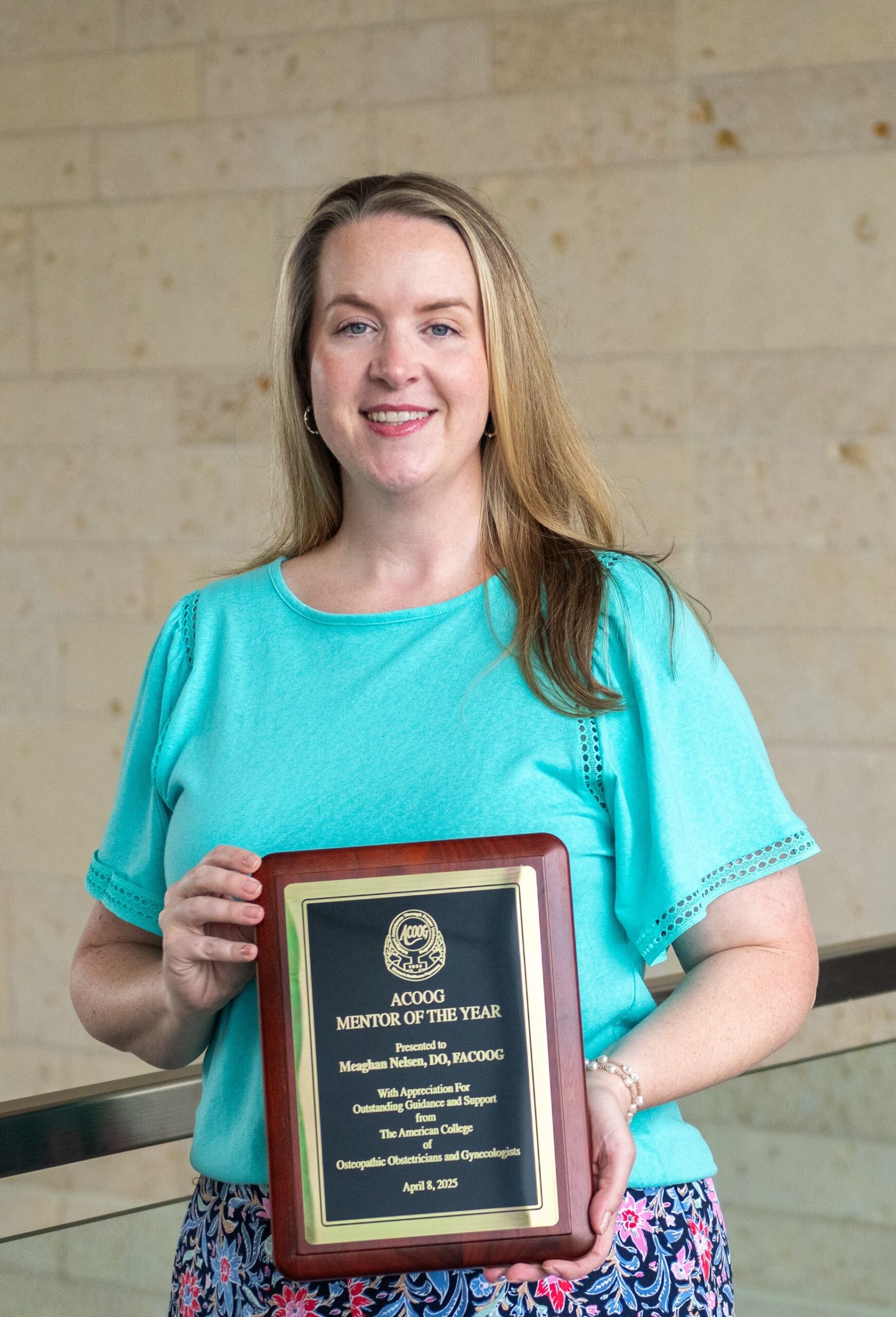 Photo of UNTHSC's Dr. Meaghan Nelsen with her ACOOG Mentor of the Year award plaque