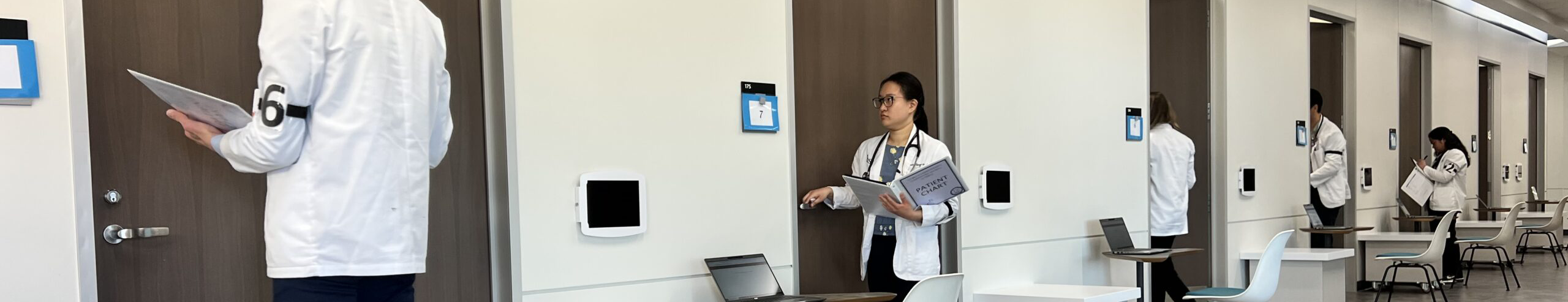 Top photo banner of 5 UNTHSC TCOM medical students entering a row of numbered rooms to interact with their training