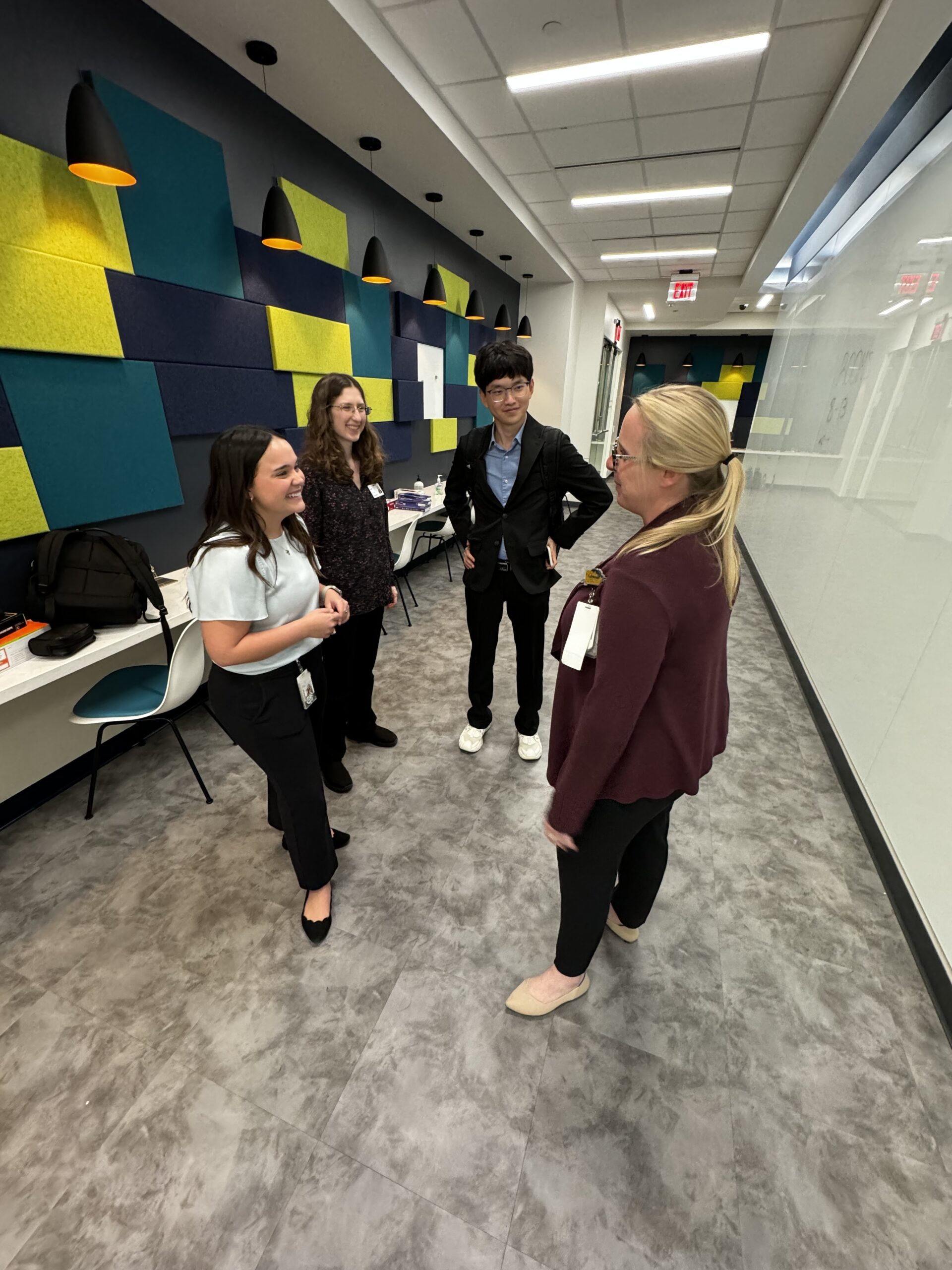 Photo of UNTHSC College of Pharmacy's Megan Wesling casually talking with 3 other people
