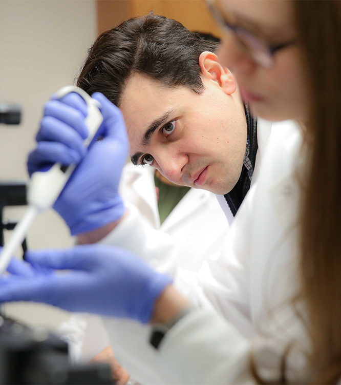Photo of 2 people working in UNTHSC's pharmacy lab