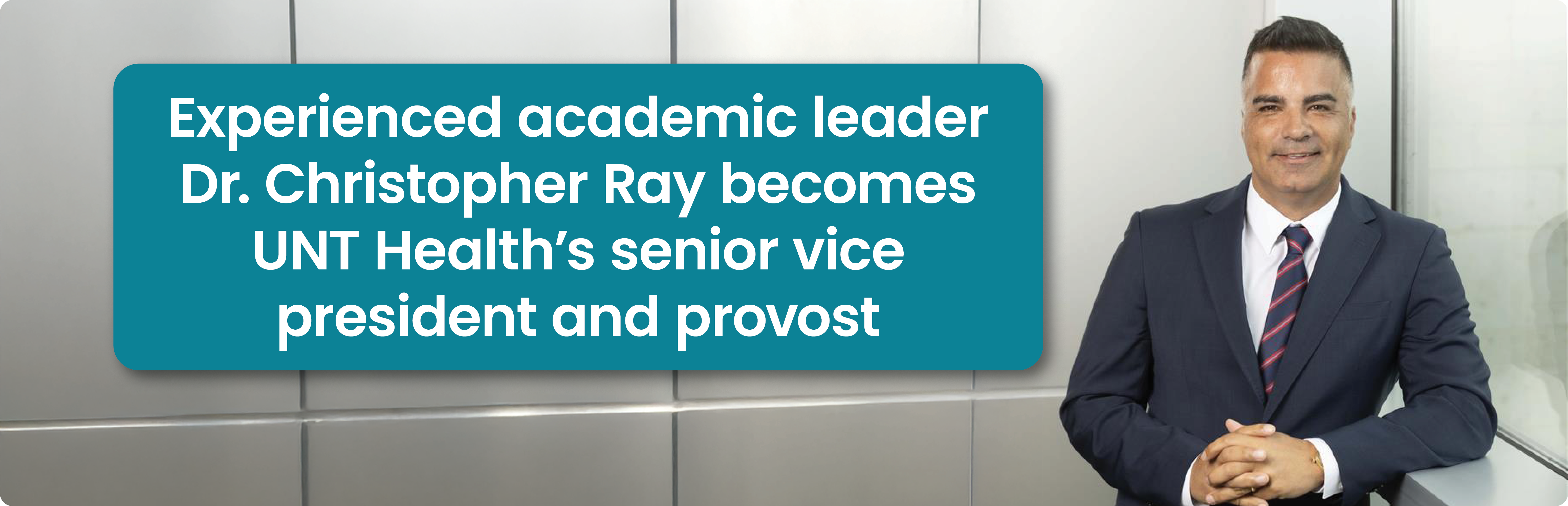 This announcement image contains a text box over a photo with the words: Experienced academic leader Dr. Christopher Ray becomes UNT Health’s senior vice president and provost. The portrait photograph shows Dr. Christopher Ray smiling in a suit and tie, his hands clasped together as he leans against the corner of a large paneled wall, his left arm resting on a ledge of a large window.