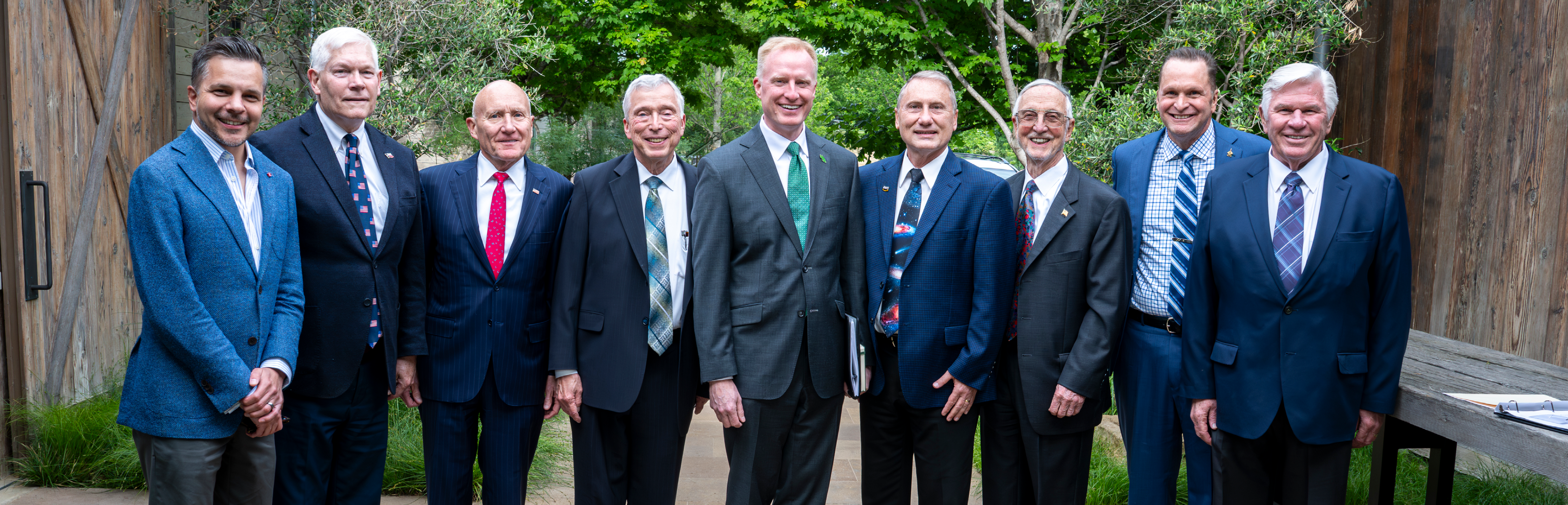 Photo from UNT's National Security and Economic Strategy Initiative inaugural summit's 9 featured experts posed standing outside