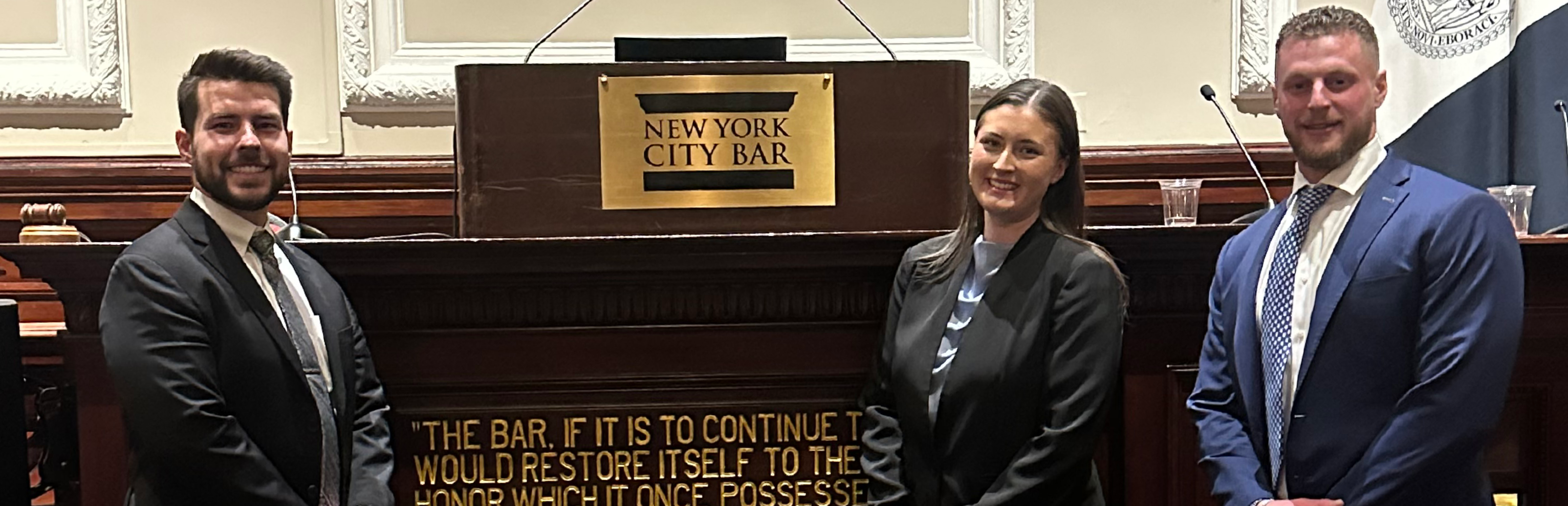 Photo of UNT Dallas College of Law 3L students Hamilton Hayers (left), Victoria Saucedo and Andrew Brown at the National Moot Court Competition courtroom.