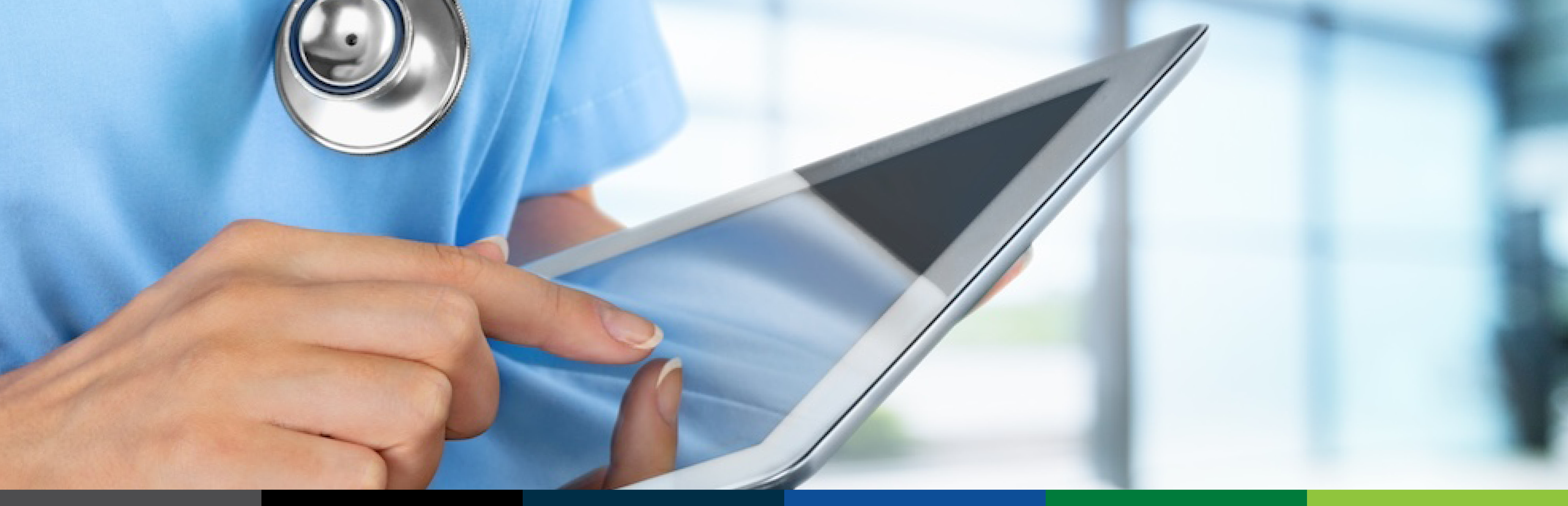 A tightly cropped, horizontally formatted image of a medical professional's chest. They are wearing a light blue scrub shirt with a stethoscope around the neck, holding a computer tablet with one hand, and the other is about to touch the screen.