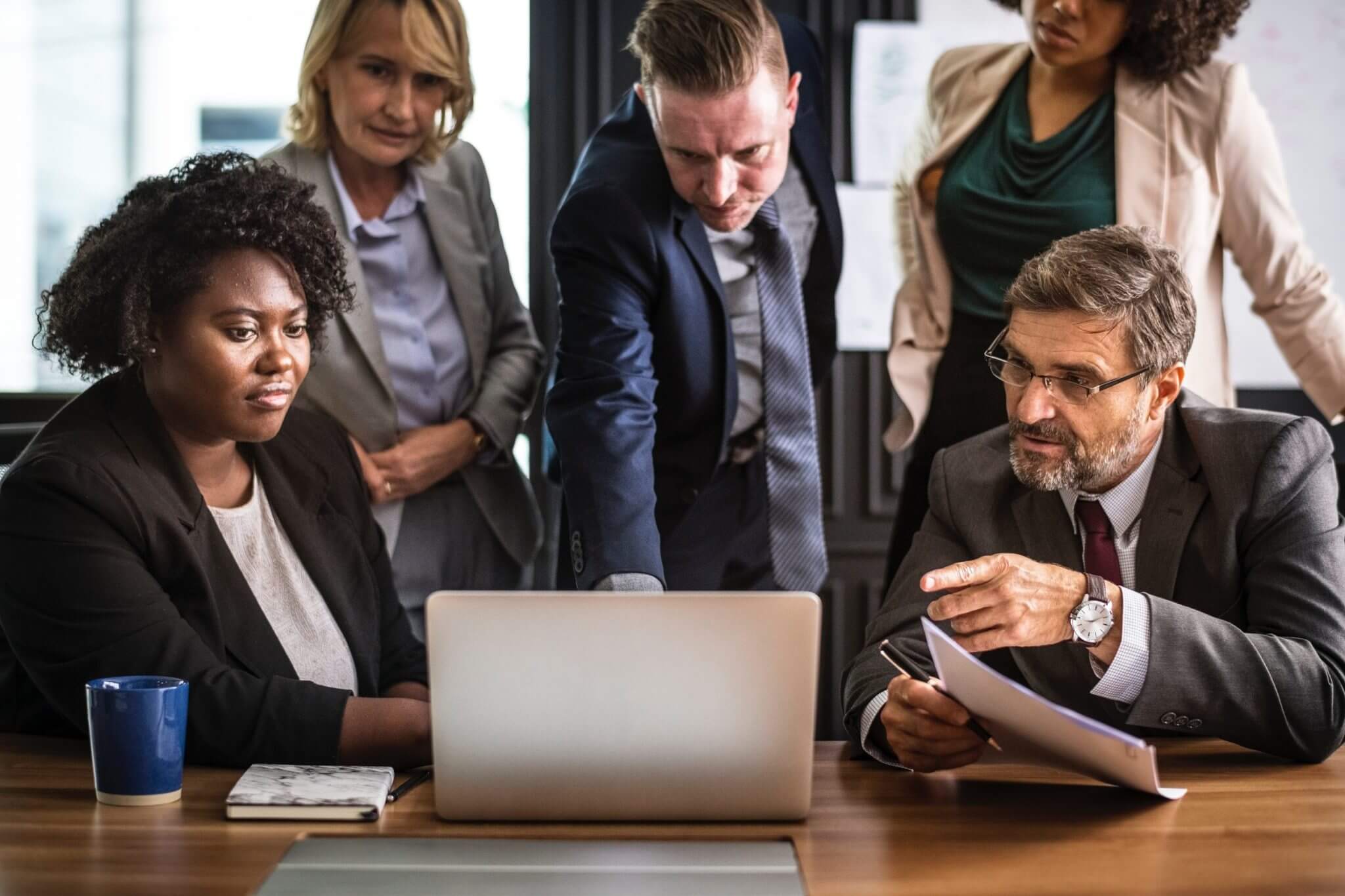Group of people looking at laptop
