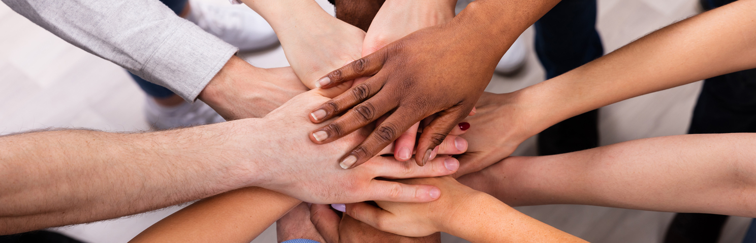 Diverse hands together, solidifying teamwork