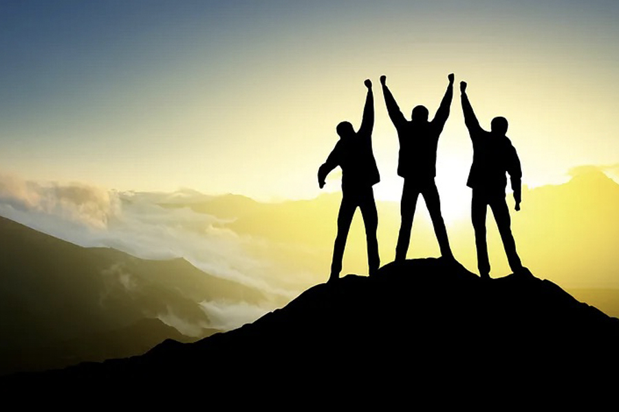 Team of people on top of a mountain